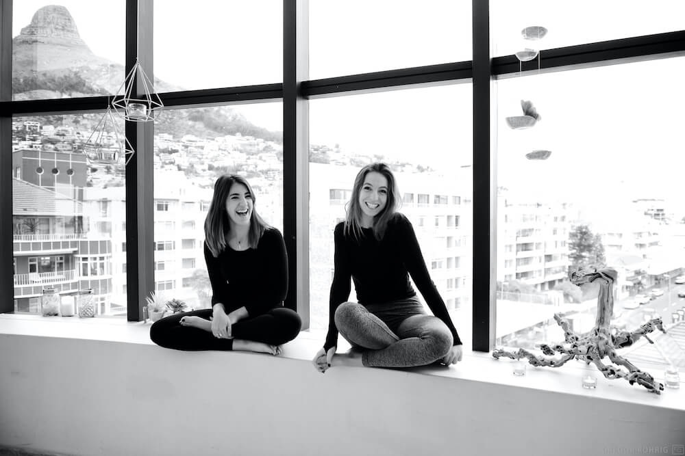 Lexi and Dom on a window sill in the Wild Things yoga studio.