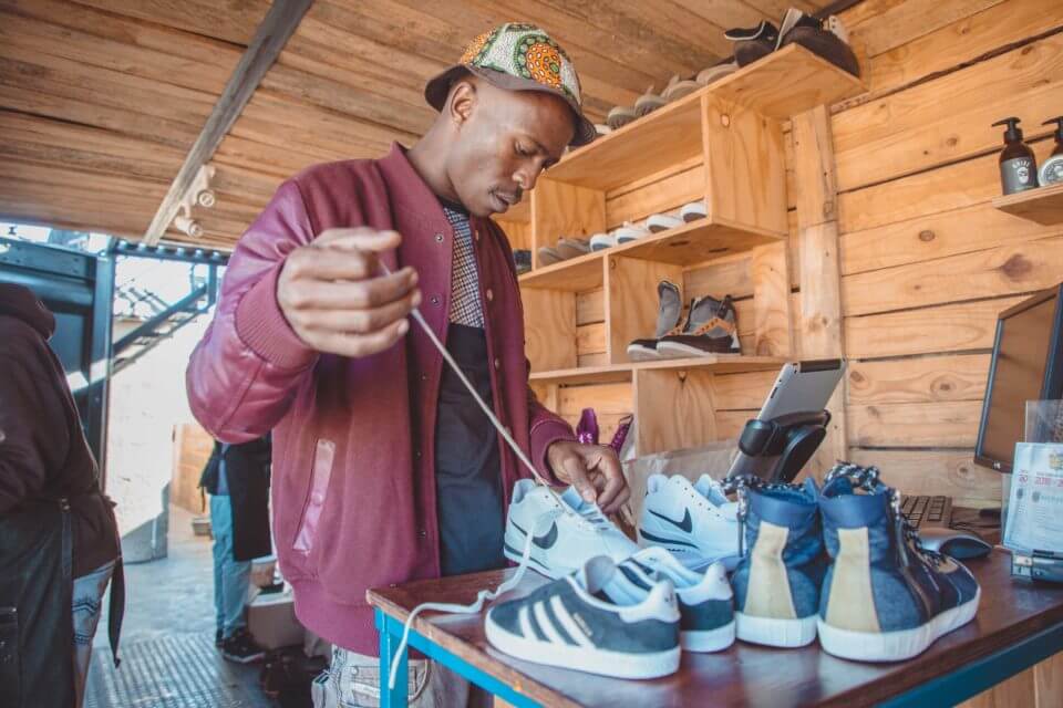 Lethabo lacing a pair of sneakers at Walk Fresh.