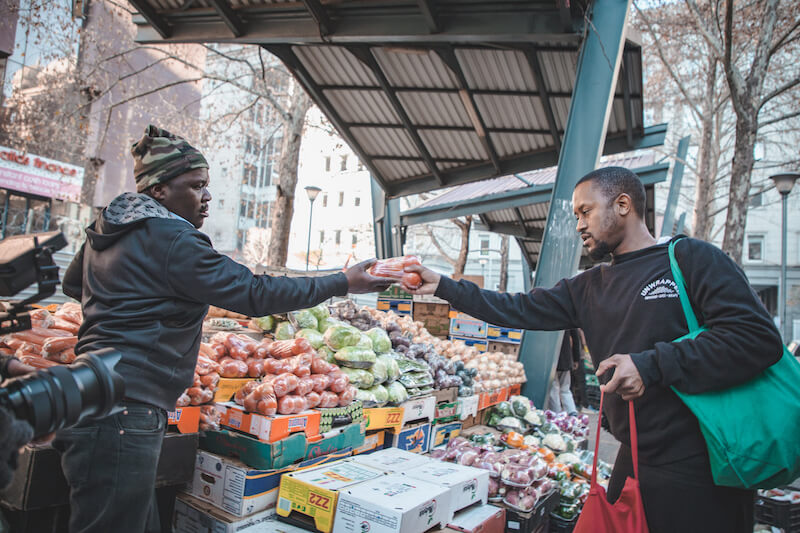 Jabu Mdluli of Unwrapped buying produce at the market.