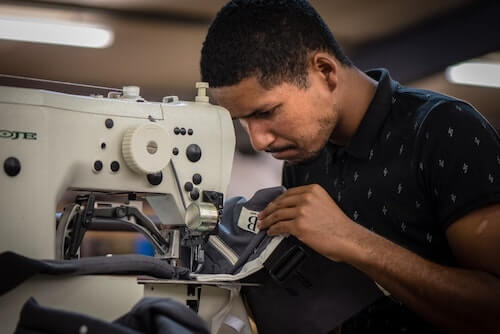 Rodney working on his sewing machine at Ubuntu Baba.