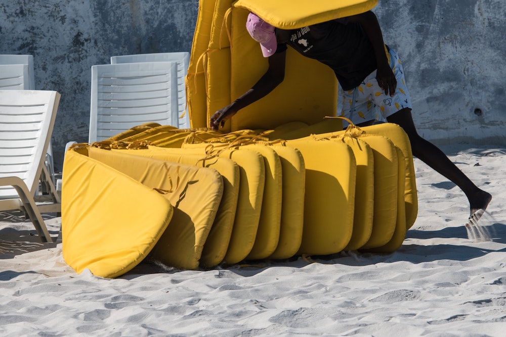 Cushions arranged on the beach.