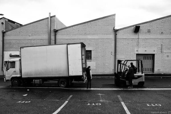 Using the forklift to lift boxes fo gin.