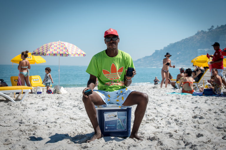 An image of a vendor sitting on a collar on Cape Town's beaches.