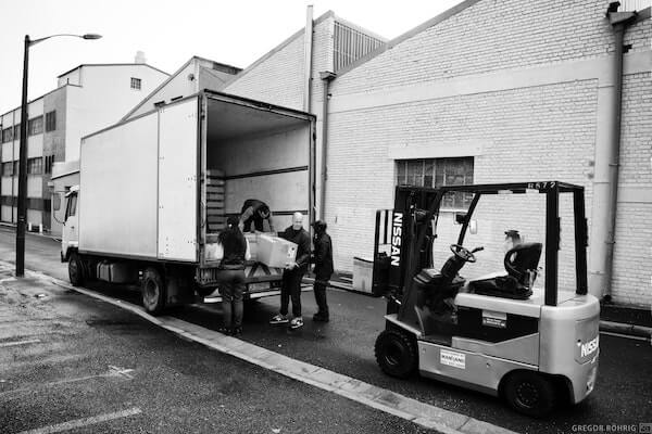 Packing boxes of gin into the truck.