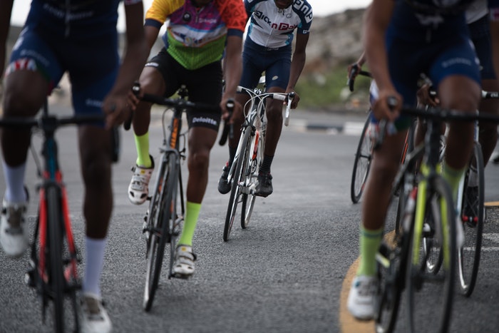 A pack of cyclists on the road.