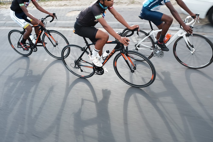 Shadows of the peloton riding the streets