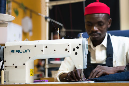 Achmed the tailor working at the sewing machine.