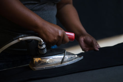 Ironing the jeans made at Tshepo the Jean Maker.