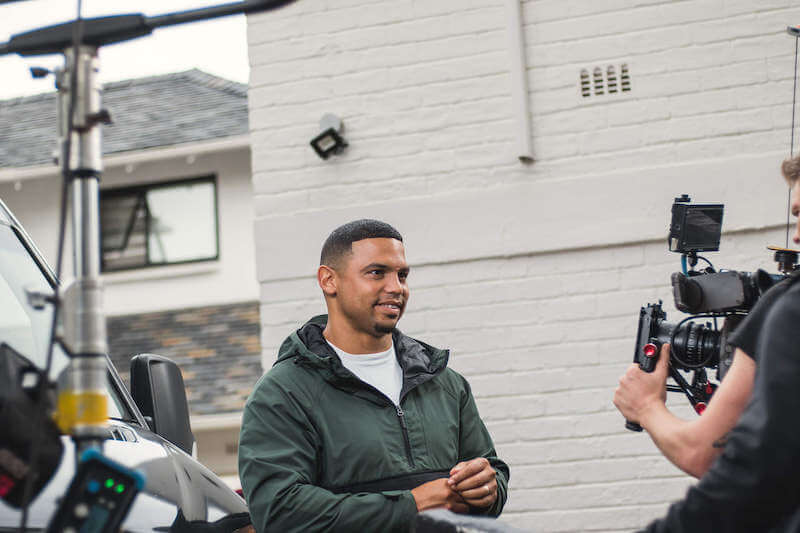 Sheldon Tatchell of Legend's Barbershop in front of camera.