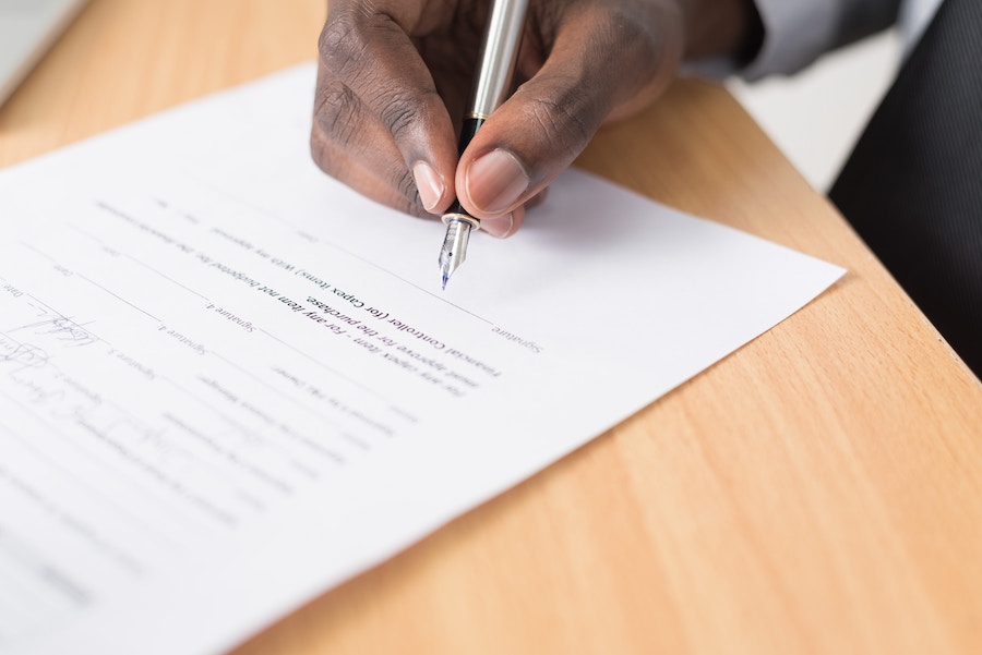 An image of a lawyer signing a contract for a new small business.