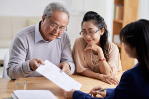 An image of two parents talking to their child in an article about getting funding from family and friends for your business.