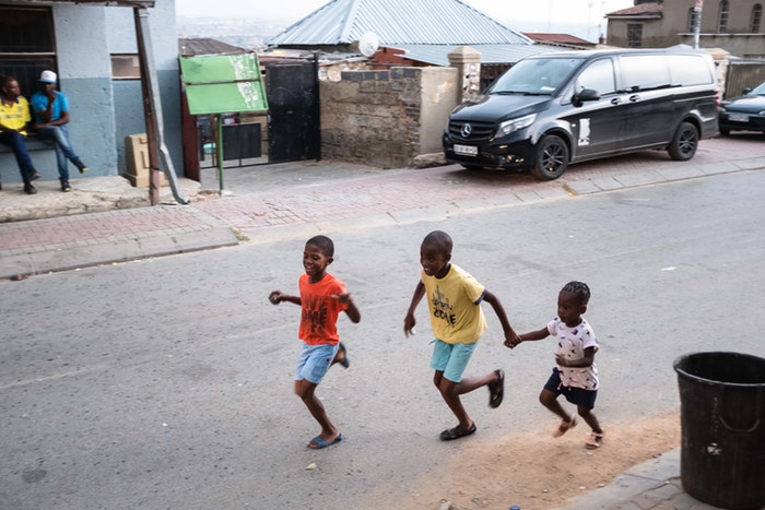 Kids playing the streets of Alex township.
