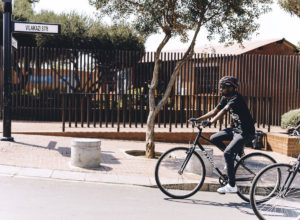 Mpumelelo Mtintso, founder of Book Ibhoni riding past Vilakazi Street.