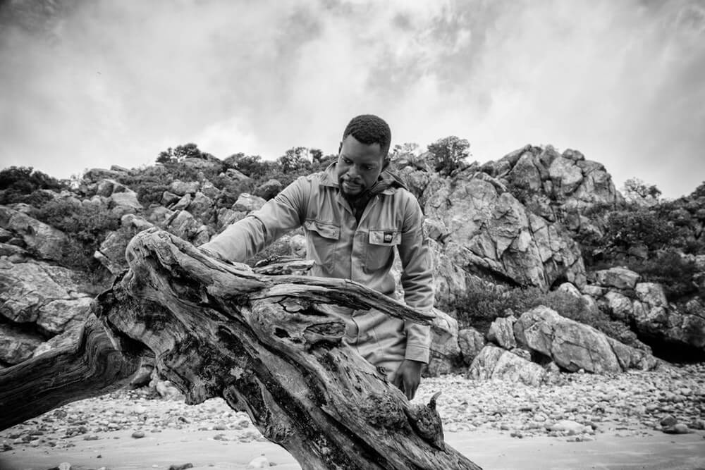 Boniface feeling the wood.