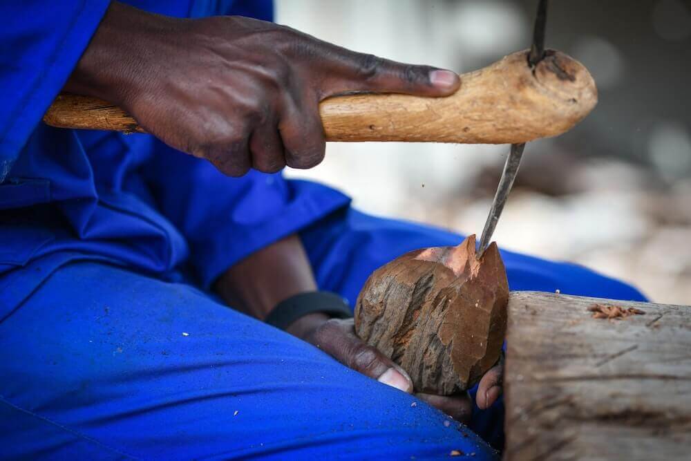 Cutting deep into the wood.