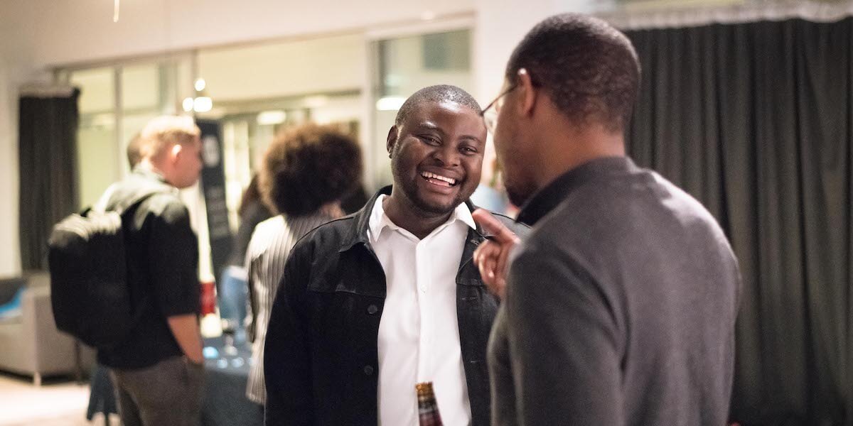two men chatting at a business networking event